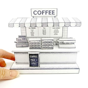 May include: A black and white illustration of a coffee shop stand with a striped awning. The stand has a sign that says "COFFEE" and a menu with hot drinks, tea, and iced drinks. There is a cash register, a display case with donuts, and a coffee machine.