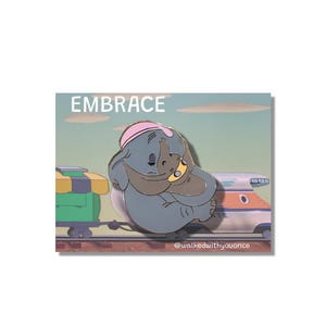 May include: A pin featuring a gray elephant embracing a smaller yellow figure, both wearing pink hats. The word "EMBRACE" is above the figures. A train and tracks are in the background. The pin is on a white background.