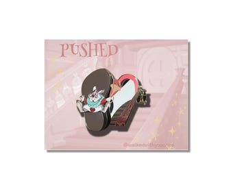 May include: A pin featuring the White Rabbit from Alice in Wonderland, pushing a piano shaped like a heart. The pin has a brown, red, and white color scheme. The word "PUSHED" is above the pin.