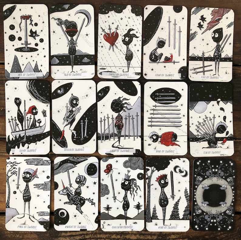 May include: A set of 14 tarot cards featuring black and white illustrations of swords and figures. The cards are part of a tarot deck called "The Swords".