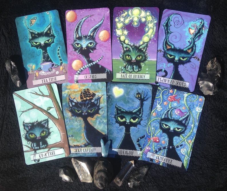 May include: A set of ten illustrated cards featuring black cats with different backgrounds and text. The cards include "Tea Time", "Up a Tree", "Cosmos", "Bait of Energy", "Twinned Souls", "Soul Captain", "Hideaway", "Guidance", "The Moon", and "The Sun".