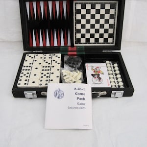 May include: A black 6-in-1 game pack with a backgammon board, chess board, dominoes, playing cards, and other game pieces. The game pack includes a booklet with game instructions.
