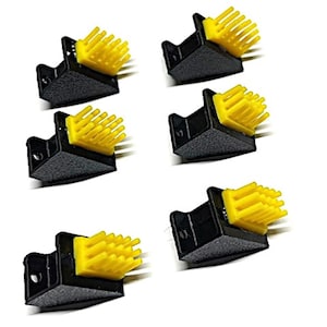 Może przedstawiać: Sześć czarnych plastikowych narożników z żółtymi, szczeciniastymi mocowaniami. Elementy są ułożone na białym tle. Żółte włosie jest prostokątne i wydaje się być wykonane z miękkiego tworzywa sztucznego.