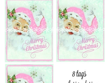 May include: Eight Christmas gift tags featuring a vintage Santa Claus illustration. Santa wears a pink hat and has a white beard. The tags have a light green background with snowflakes and the words "Merry Christmas". The text "8 tags exclusive design by Cottage Rose Graphics" is also present.