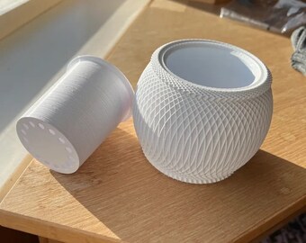 May include: White ceramic planter with a geometric pattern and a separate white plastic drainage cup.