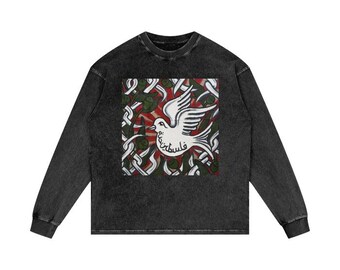 May include: A dark gray long-sleeve shirt featuring a square graphic of a white dove with an olive branch, set against a red and green background. The dove has Arabic text below it. The shirt has a crew neck and long sleeves.