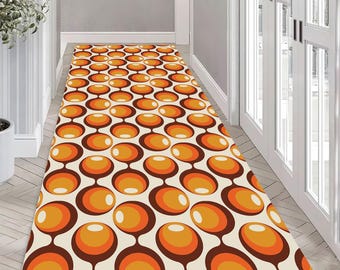 May include: A white runner rug with a repeating pattern of orange and brown circles. The circles are connected by thin brown lines.