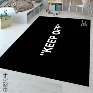 Puede incluir: Alfombra negra y blanca con el texto "KEEP OFF" impreso en blanco. La alfombra est&aacute; hecha de un material suave y duradero y es perfecta para &aacute;reas de mucho tr&aacute;fico.