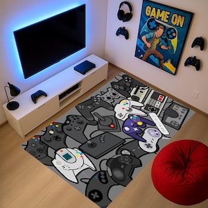May include: A grey rug patterned with a variety of video game controllers in shades of grey and white. The rug is in a room with a TV, a white entertainment unit, and a red beanbag chair.