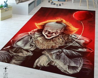 May include: A red and white rug with a scary clown holding a red balloon. The clown has a white face with red lips and a red nose. The rug has a 3D effect and is machine washable.