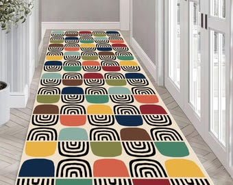 May include: A rectangular hallway rug with a repeating pattern of colorful, rounded rectangles and black semi-circles. The rug features a cream background and blocks of blue, green, yellow, orange, red, and brown. The rug is a decorative element for a hallway.