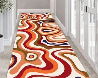May include: Abstract area rug with a wavy, flowing pattern in shades of red, orange, brown, and blue. The rug has a white background and is perfect for adding a modern touch to any room.