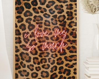 May include: A framed print with a leopard print background and the text "i love me so much" in pink neon lettering.