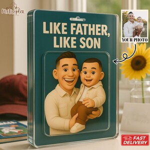 May include: A teal-colored display case with the text "LIKE FATHER, LIKE SON" features a 3D rendering of a father and son. The case includes a small photo and a sunflower. The words "YOUR PHOTO" are printed on the photo.