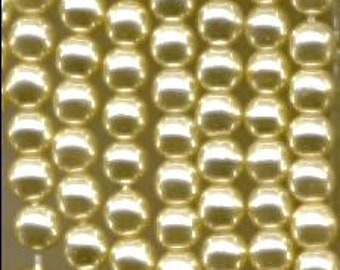 May include: A strand of cream-colored pearl beads. The beads are round and have a smooth, glossy finish.