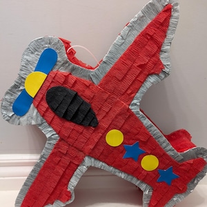 Airplane cute piñata for kids birthday party. Pinata game