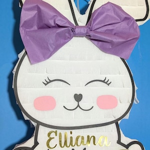 Bunny piñata for kids party. Easter Pinata party. Piñata game