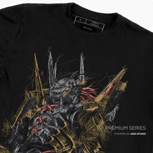 May include: Black t-shirt with a white and gold line art illustration of a robot or monster. The illustration is in a scribble style. The text "PREMIUM SERIES POWERED by OZZI STUDIO" is at the bottom of the shirt.