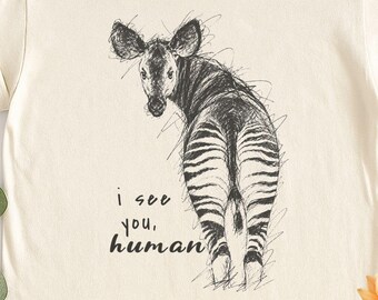 Camiseta Comfort Colors con dibujo de okapi, camiseta "Te veo, humano", camiseta gráfica de animales salvajes africanos, regalo para adultos y jóvenes.