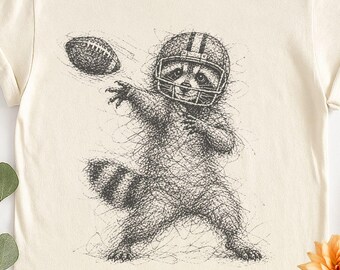 Camiseta con dibujo de mapache jugando al fútbol, ​​camiseta vintage con estampado de animales deportivos, camiseta Comfort Colors para el día del partido de fútbol. Regalo ideal.