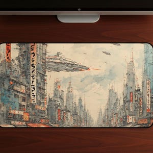 May include: A rectangular mouse mat depicting a futuristic city with high-rise buildings and flying spacecraft. The artwork is in a watercolour style, with a colour palette of blues, greys, and oranges. The mouse mat has a black border and is set against a wooden surface.