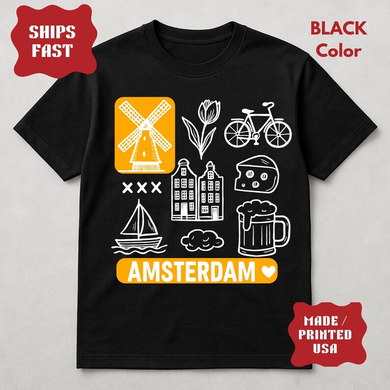 Pu&ograve; includere: T-shirt nero con grafica bianca a tema Amsterdam, tra cui un mulino a vento, un tulipano, una bicicletta, formaggio, case, una barca a vela, un boccale di birra e la scritta "AMSTERDAM". La maglietta ha anche il testo "BLACK Color" e "MADE / PRINTED USA".