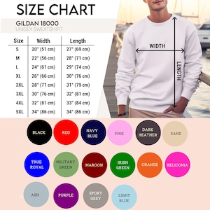 May include: A Gildan 18000 unisex sweatshirt size chart featuring a white crewneck sweatshirt with width and length measurement arrows. The chart lists sizes S to 5XL with imperial and metric dimensions. Below are color swatches for 17 options.
