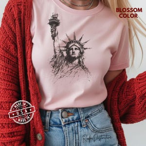 Statue of Liberty graphic t-shirt featuring a patriotic vintage-style New York design, perfect for American pride and freedom lovers.