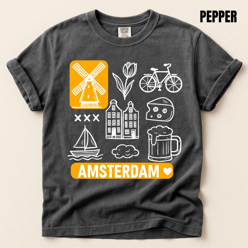 pepper  t-shirt with white graphic icons of a windmill, tulips, bicycle, houses, cheese, beer, and a sailboat. The word "AMSTERDAM" is in orange.