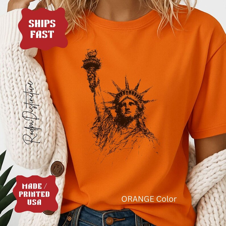 Statue of Liberty graphic t-shirt featuring a patriotic vintage-style New York design, perfect for American pride and freedom lovers.