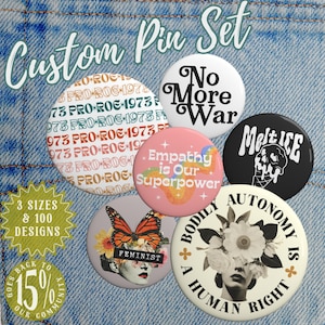May include: A custom pin set featuring six unique designs on a denim background. The pins include text like "No More War," "Empathy is Our Superpower," and "Bodily Autonomy is a Human Right." Other pins feature a butterfly, floral designs, and the text "PRO-ROE 1973."