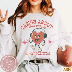 Caring About Other People Is Not Political Crewneck Sweatshirt Vintage Cartoon Progressive Liberal Activist Heart Social Justice Human Right