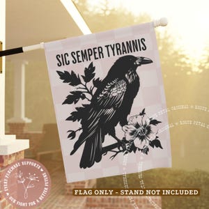 May include: A decorative flag featuring a black raven perched on a branch with flowers, set against a pink and white checkered background. The flag reads "SIC SEMPER TYRANNIS" in bold letters.