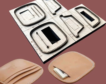 May include: A set of leather craft punches for making a wallet. The punches are made of metal and have a wooden base. The punches are used to cut out shapes from leather. There are two finished wallets made from leather, one with a billfold and the other with three card slots.