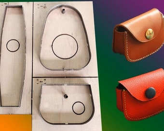May include: A set of three leather cutting dies for crafting small purses or pouches. The dies are made of metal and are mounted on a wooden base. The dies are used to cut out the shapes of the purses or pouches from leather.