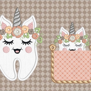May include: Two embroidered tooth-shaped cushions with unicorn faces. The first cushion is a white tooth with a silver horn, pink cheeks, and a flower crown. The second cushion is a white tooth with a silver horn, pink cheeks, and a flower crown inside a pink and gold pocket.