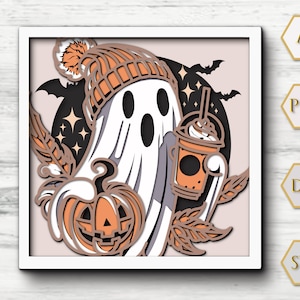 May include: A layered paper art piece featuring a friendly ghost wearing an orange beanie and holding a pumpkin and a pumpkin spice latte. The background includes bats, stars, and leaves, all in shades of orange, black, and white.