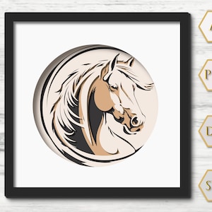 May include: A framed paper art piece showing a horse's head in profile. The horse is in tan and brown shades, set against a cream-coloured circular background. The artwork is framed in a black square frame.