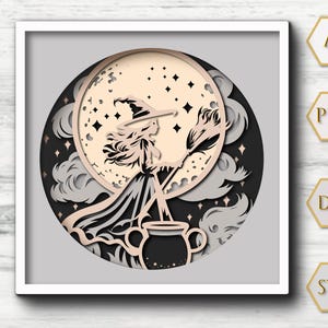 May include: A layered paper art piece featuring a witch silhouette with a broom, hat, and dress, set against a full moon and dark night sky. The artwork includes a cauldron and cloud details, all within a square frame.