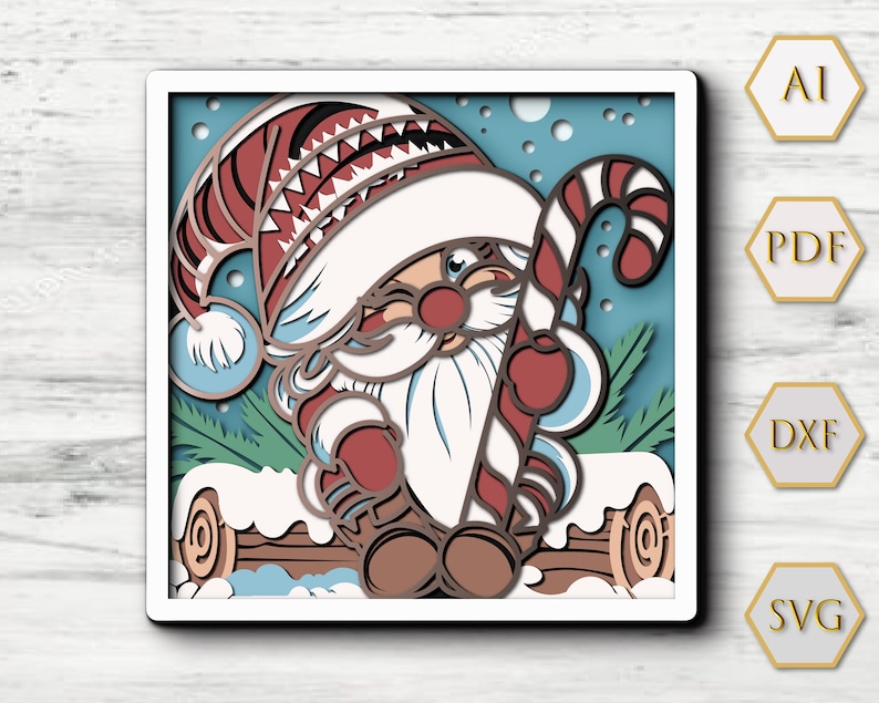 May include: A multi-layered square wall art piece featuring a gnome wearing a red and white hat, holding a red and white candy cane, sitting on a log covered in snow against a light blue background with snowflakes. The text AI, PDF, DXF, and SVG appear in hexagons.