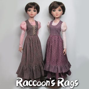 May include: Two dolls wearing long, purple and pink floral print dresses with ruffled hems. The dolls have brown hair and are wearing pink blouses with puffed sleeves. The dolls are standing on a white background. The text "Raccoon's Rags" is at the bottom of the image.