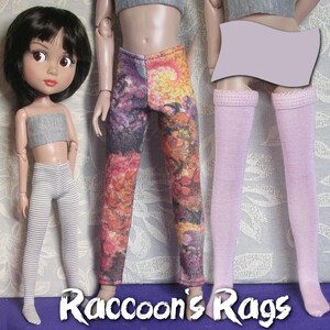 May include: Three pairs of doll leggings, one pair is striped, one pair is pink, and one pair has a colorful floral print. The leggings are all made for dolls.