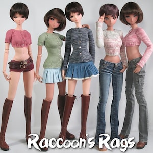 May include: Five dolls wearing different knitted cardigans and skirts. The dolls are wearing brown boots and have long black hair. The cardigans are in various colors, including pink, green, gray, and white. The skirts are also in various colors, including blue, green, and white. The dolls are standing in a row, and the image is taken from a slightly elevated angle.