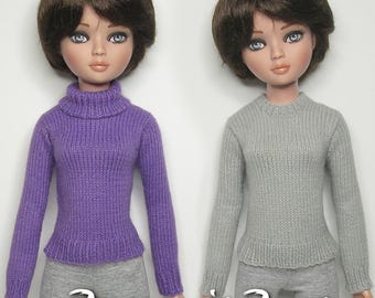 May include: Two dolls wearing knitted sweaters. The doll on the left is wearing a purple sweater and the doll on the right is wearing a gray sweater. Both dolls have brown hair and blue eyes. The text "Raccoon's Rags" is visible at the bottom of the image.