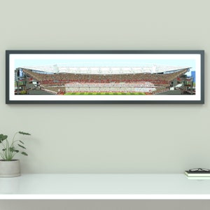 May include: A panoramic view of a large stadium with a white roof and a crowd of people in the stands. The stadium is shown in cross-section, revealing the internal structure and seating.