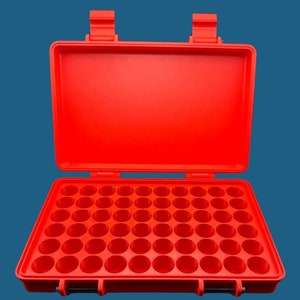 May include: A red plastic storage case with 48 individual compartments. The case is open and the compartments are visible.
