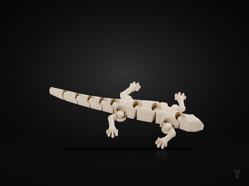 May include: A light-colored, articulated wooden lizard figurine featuring a segmented body and tail design. The lizard has four detailed feet with visible toes and a textured surface, showcasing a flexible structure with visible joints.