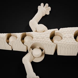 May include: An off-white, articulated lizard figurine featuring a textured, scale-like surface pattern. The creature is composed of multiple segmented sections connected by ball-and-socket joints, allowing for flexible movement.