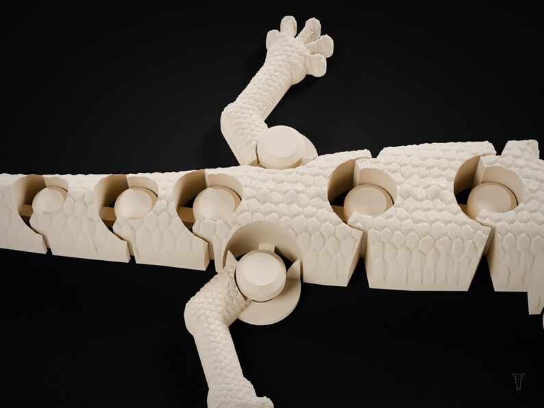 May include: An off-white, articulated lizard figurine featuring a textured, scale-like surface pattern. The creature is composed of multiple segmented sections connected by ball-and-socket joints, allowing for flexible movement.