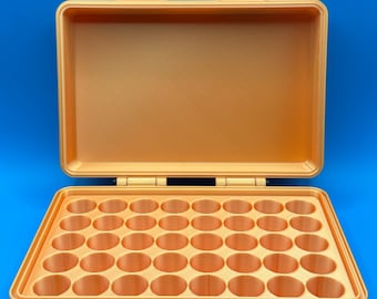 May include: A rectangular, light orange storage case with an open lid and two top hinges. The interior base features a grid of forty circular compartments arranged in five rows of eight, designed for holding small cylindrical items securely.